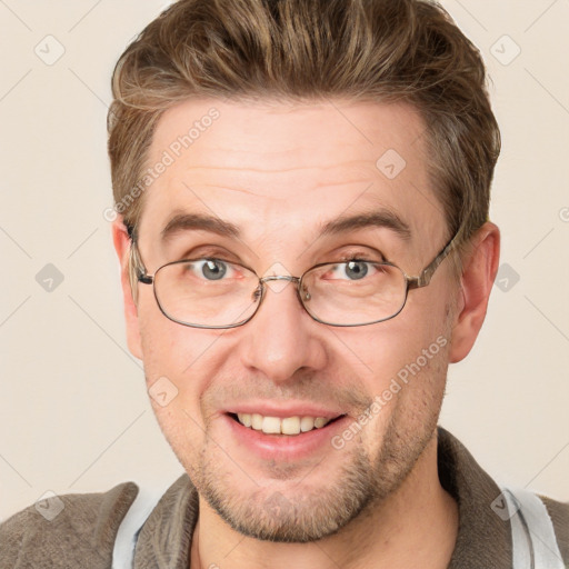 Joyful white adult male with short  brown hair and grey eyes