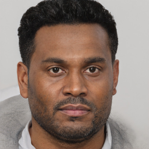 Neutral black young-adult male with short  black hair and brown eyes