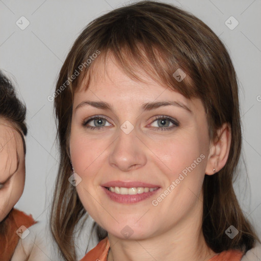 Joyful white young-adult female with medium  brown hair and blue eyes