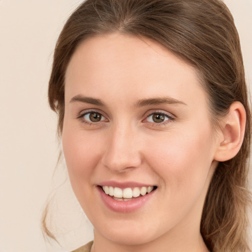 Joyful white young-adult female with long  brown hair and green eyes