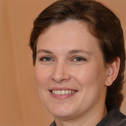 Joyful white adult female with medium  brown hair and brown eyes