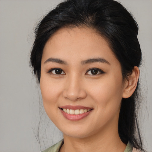 Joyful asian young-adult female with medium  brown hair and brown eyes