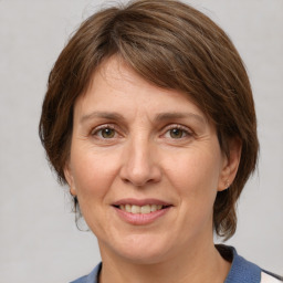 Joyful white adult female with medium  brown hair and grey eyes