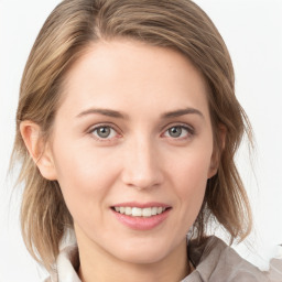 Joyful white young-adult female with medium  brown hair and blue eyes