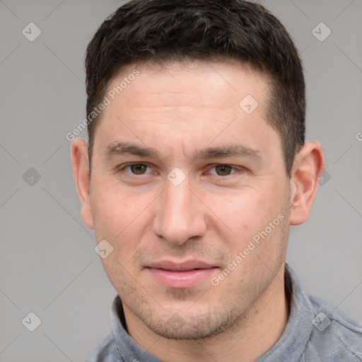 Joyful white young-adult male with short  brown hair and grey eyes