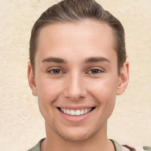 Joyful white young-adult male with short  brown hair and brown eyes