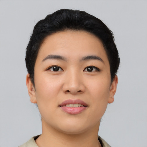 Joyful asian young-adult female with short  black hair and brown eyes