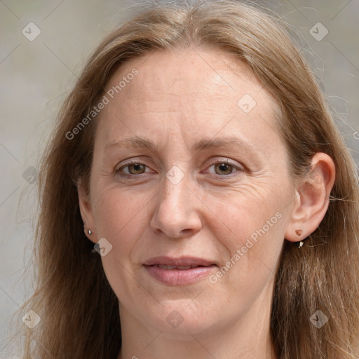 Joyful white adult female with long  brown hair and grey eyes