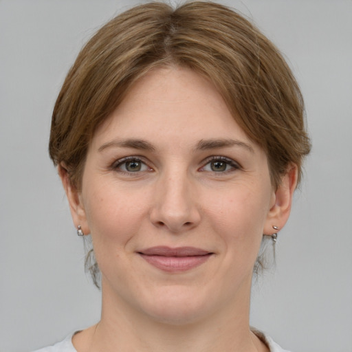 Joyful white young-adult female with medium  brown hair and grey eyes