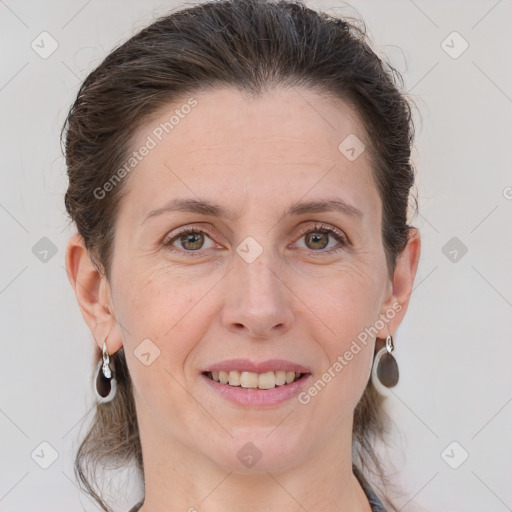 Joyful white adult female with medium  brown hair and grey eyes