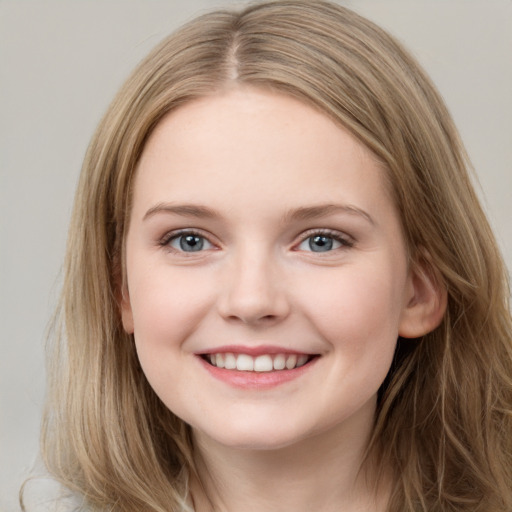 Joyful white child female with long  brown hair and grey eyes