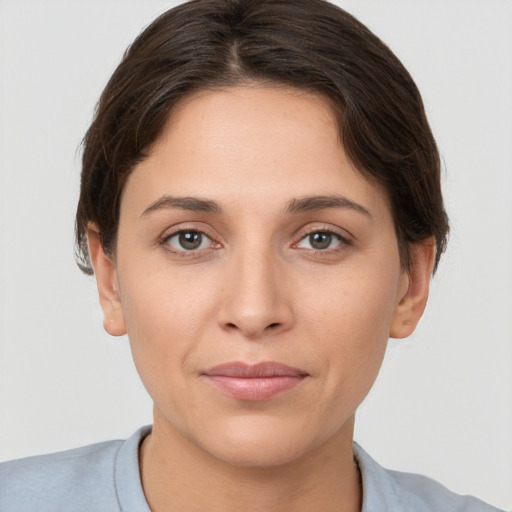 Joyful white young-adult female with short  brown hair and brown eyes