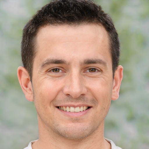 Joyful white young-adult male with short  brown hair and brown eyes