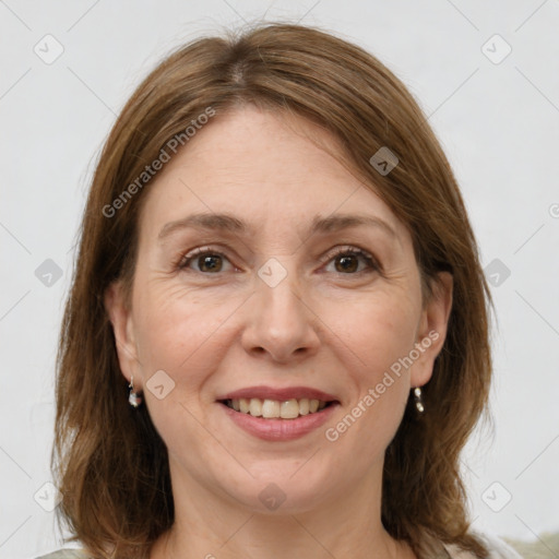 Joyful white adult female with medium  brown hair and grey eyes