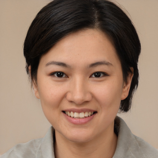 Joyful white young-adult female with medium  brown hair and brown eyes