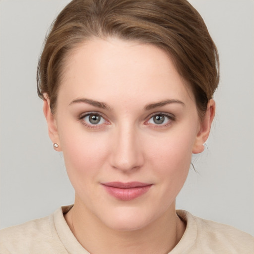 Joyful white young-adult female with short  brown hair and grey eyes