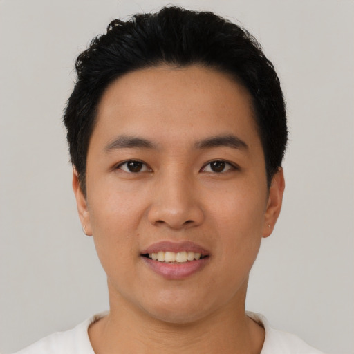 Joyful asian young-adult male with short  black hair and brown eyes