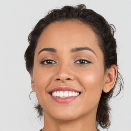 Joyful latino young-adult female with medium  brown hair and brown eyes