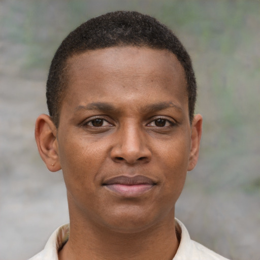 Joyful latino young-adult male with short  brown hair and brown eyes