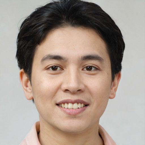 Joyful asian young-adult male with short  brown hair and brown eyes