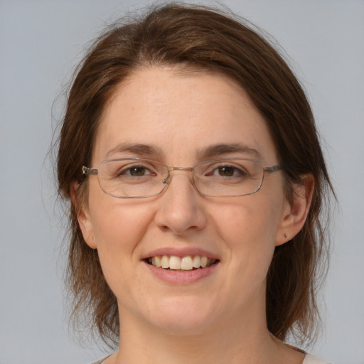 Joyful white adult female with medium  brown hair and brown eyes