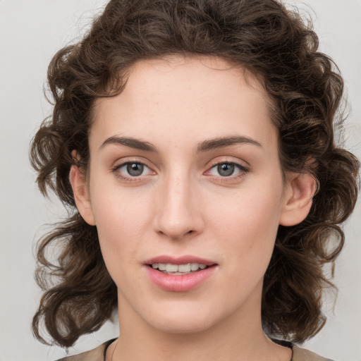 Joyful white young-adult female with medium  brown hair and green eyes