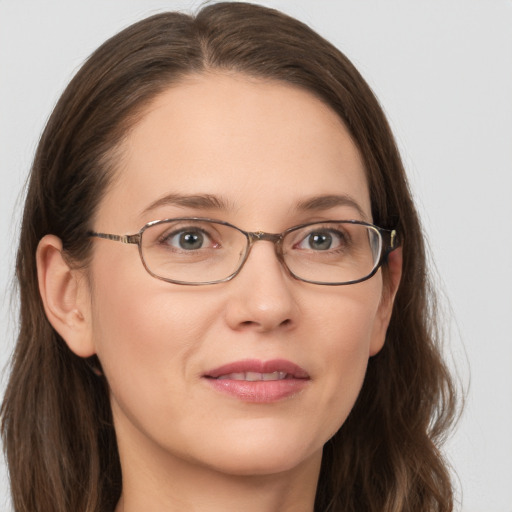 Joyful white young-adult female with long  brown hair and grey eyes