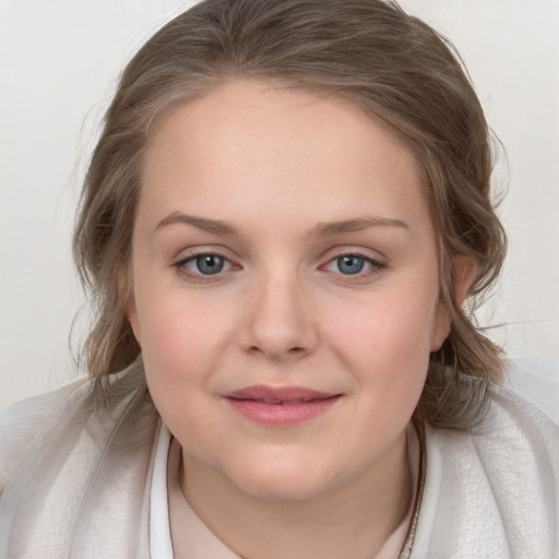 Joyful white young-adult female with medium  brown hair and blue eyes