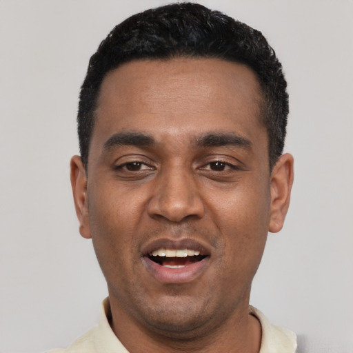 Joyful black young-adult male with short  black hair and brown eyes