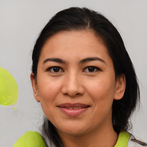 Joyful latino adult female with medium  brown hair and brown eyes