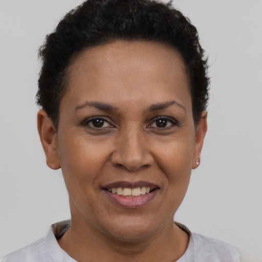 Joyful latino adult female with short  black hair and brown eyes