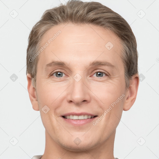 Joyful white adult male with short  brown hair and grey eyes