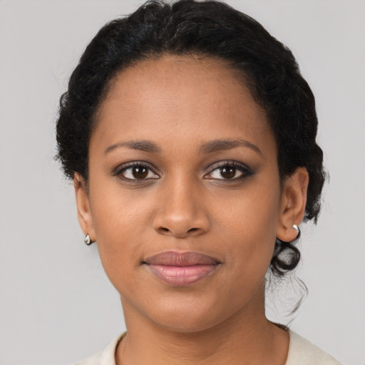 Joyful black young-adult female with short  brown hair and brown eyes