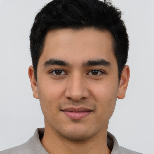 Joyful asian young-adult male with short  black hair and brown eyes