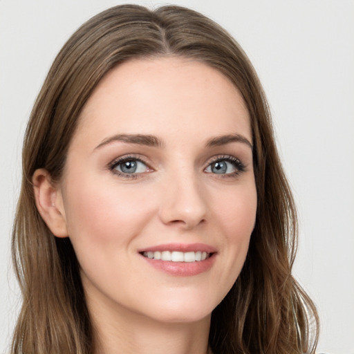 Joyful white young-adult female with long  brown hair and grey eyes