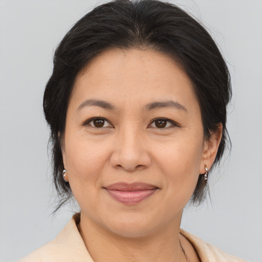 Joyful asian adult female with medium  brown hair and brown eyes