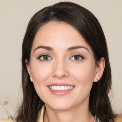 Joyful white young-adult female with long  brown hair and brown eyes