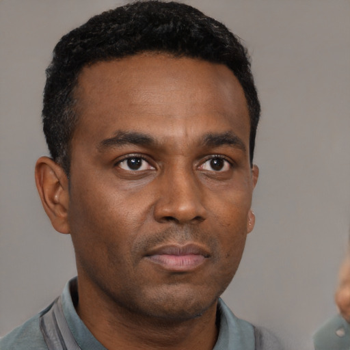 Neutral black young-adult male with short  black hair and brown eyes