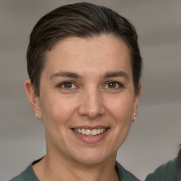 Joyful white adult female with short  brown hair and grey eyes