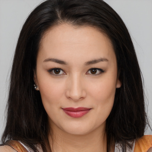 Joyful asian young-adult female with long  brown hair and brown eyes