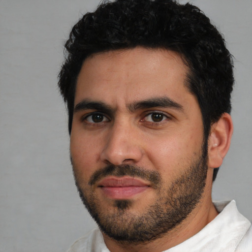 Joyful white young-adult male with short  black hair and brown eyes