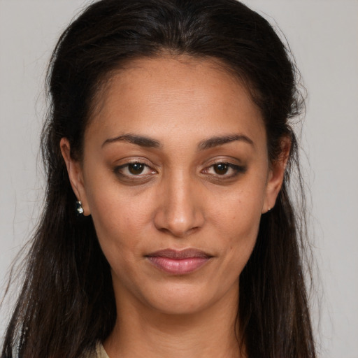 Joyful white young-adult female with long  brown hair and brown eyes