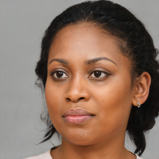 Joyful black young-adult female with medium  brown hair and brown eyes