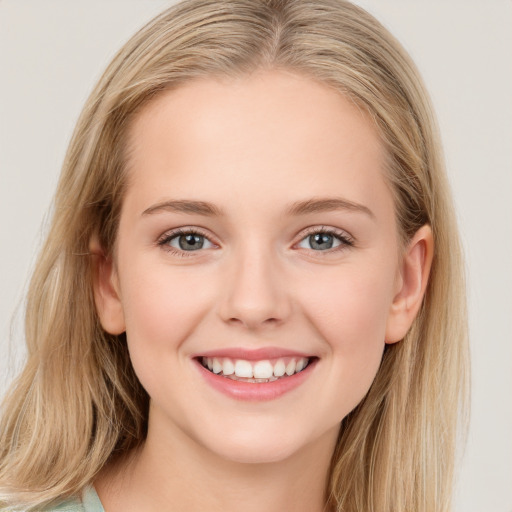 Joyful white young-adult female with long  brown hair and blue eyes