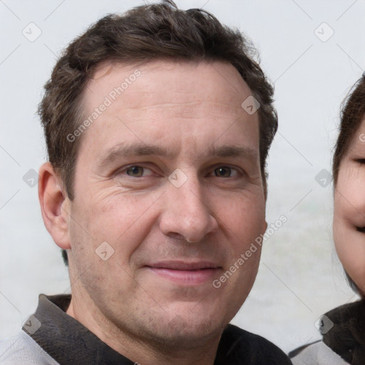 Joyful white adult male with short  brown hair and grey eyes