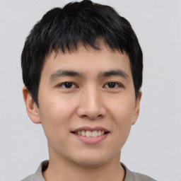 Joyful asian young-adult male with short  brown hair and brown eyes