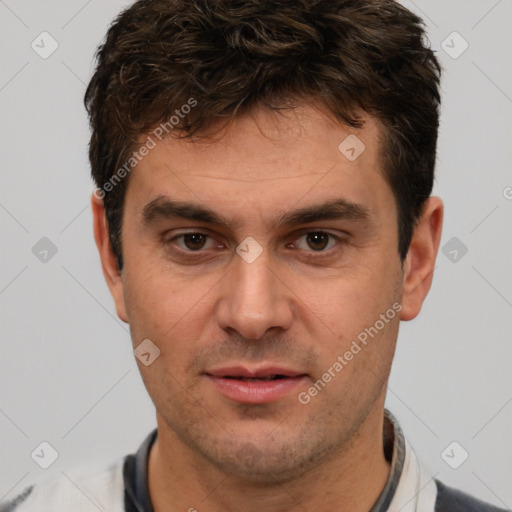 Joyful white adult male with short  brown hair and brown eyes