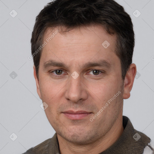 Joyful white adult male with short  brown hair and brown eyes