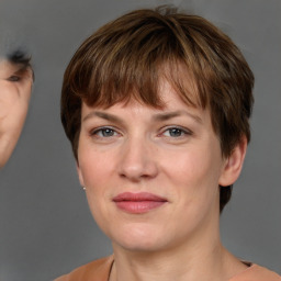 Joyful white adult female with short  brown hair and grey eyes