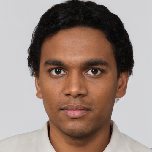 Neutral latino young-adult male with short  black hair and brown eyes